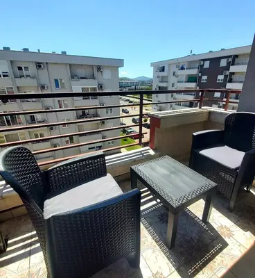 a balcony with chairs and a table on a building at Royal in Podgorica
