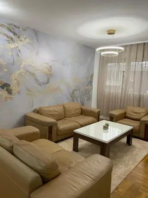 a living room with a couch and a table at Royal in Podgorica