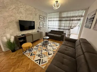 a living room with a couch and a television at Apartman Budva 1 in Budva