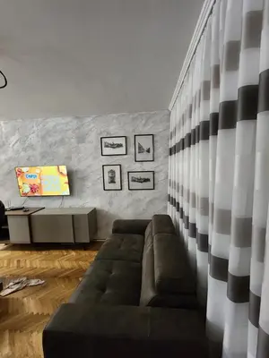 a living room with a couch and a wall at Apartman Budva 1 in Budva