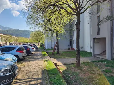 a street with cars parked on the side of a building at Apartman Budva 1 in Budva