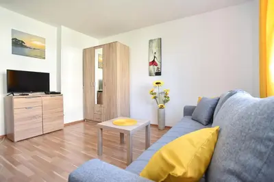 a living room with a blue couch and a table at Apartment near Old Town in Budva