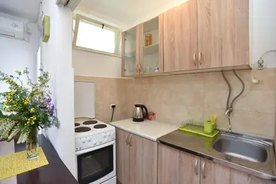 a small kitchen with a sink and a stove at Apartment near Old Town in Budva