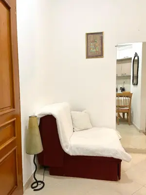 a living room with a chair and a lamp at Apartment Kralj in Kotor