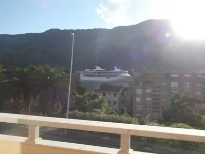 a cruise ship is docked in a city at Apartment Kralj in Kotor