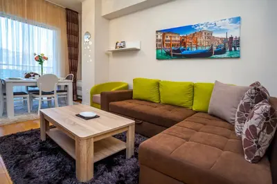 a living room with a couch and a table at Luxury Apartment Anastasia Tre canne in Budva