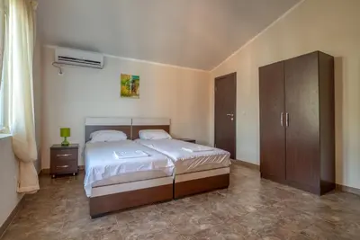 a bedroom with a bed and a cabinet in it at Vila Bronhi in Sutomore
