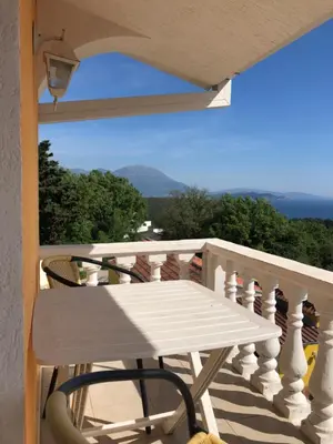 a white bench sitting on a balcony with a view at Vila Bronhi in Sutomore