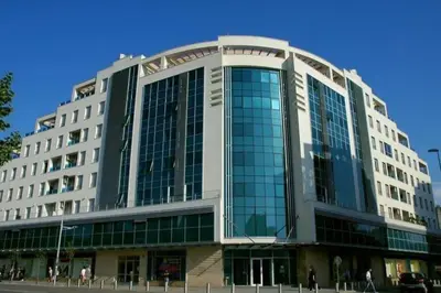 a large building with a lot of glass windows at Central Rusitc Apartment in Podgorica