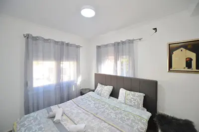 a bedroom with a bed and a window at the Right Choice Apartment in Kotor