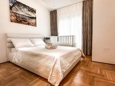 a bedroom with a bed and a large window at AvR Barka Budva in Budva