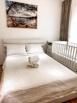 a bedroom with a bed with two towels on it at AvR Barka Budva in Budva