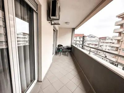 a balcony with a table and chairs on it at AvR Barka Budva in Budva