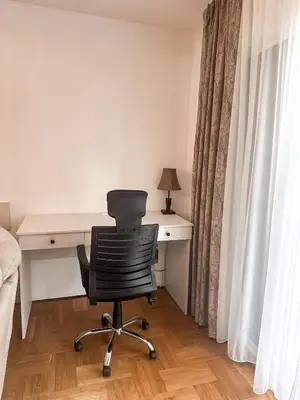 a bedroom with a desk and a chair next to a bed at AvR Barka Budva in Budva