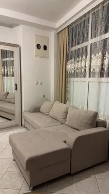 a living room with a couch and a window at Sea in Ulcinj