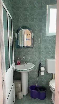 a bathroom with a sink and a toilet and a mirror at Sea in Ulcinj