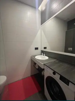 a bathroom with a washing machine and a sink at Beach Pearl in Sutomore