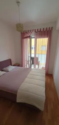 a bedroom with a large bed and a window at Odmor u Podgorici. in Podgorica