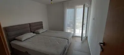 a bedroom with a bed and a large window at Biserni Apartman 1 in Kotor
