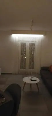 a living room with a table and a couch at Biserni Apartman 1 in Kotor