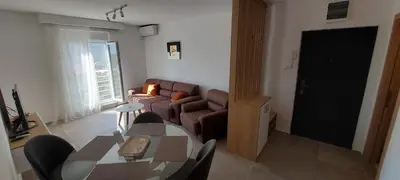 a living room with a table and a couch at Biserni Apartman 1 in Kotor