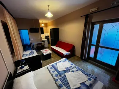a living room with a bed and a window at Apartmani Dresic in Sutomore