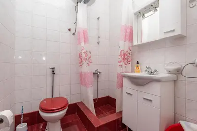a bathroom with a toilet and a sink at Apartmani Dresic in Sutomore