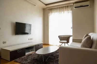 a living room with a couch and a tv at Vista Suite in Budva