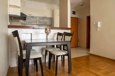 a dining room table and chairs in a kitchen at Vista Suite in Budva