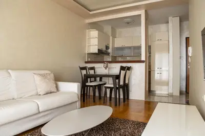 a living room with a white couch and a table at Vista Suite in Budva