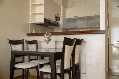 a dining room with a black table and chairs at Vista Suite in Budva
