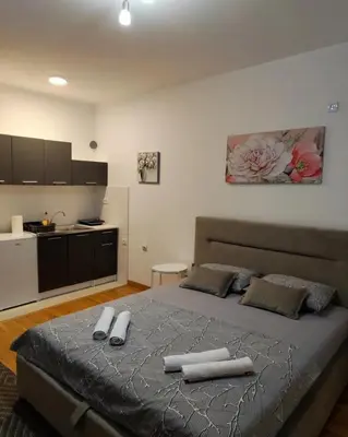 a bedroom with a large bed with two towels on it at Apartment Stefan in Budva