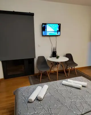 a living room with a tv and a table and chairs at Apartment Stefan in Budva