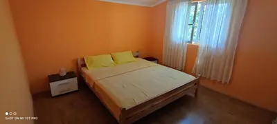 a bedroom with a bed with yellow pillows and a window at Summer Paradise, Bar in Bar