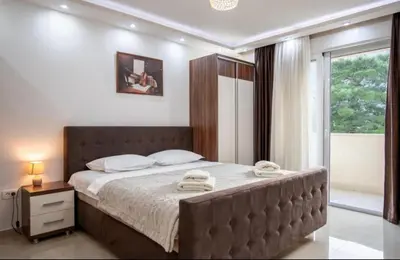 a bedroom with a large bed with towels on it at Apartmani Milica Mica Kotor Dobrota in Kotor