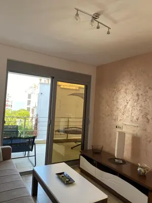 a living room with a couch and a table at Sunrise Apartments 1 in Dobra Voda