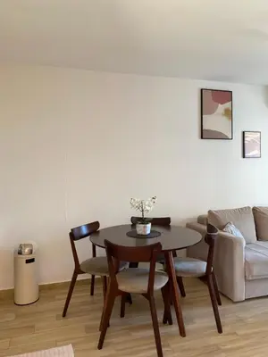 a living room with a table and chairs and a couch at Sunrise Apartments 1 in Dobra Voda