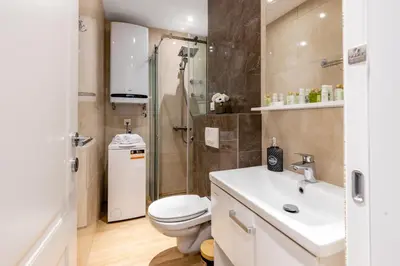 a bathroom with a toilet and a shower and a sink at Apartman DELUXE in Budva