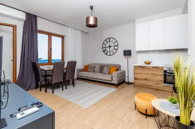 a living room with a couch and a table at Apartman DELUXE in Budva