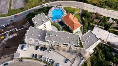 an overhead view of a building with a pool at Apartman DELUXE in Budva