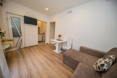 a living room with a couch and a table at Apartmani Stari Grad in Sutomore
