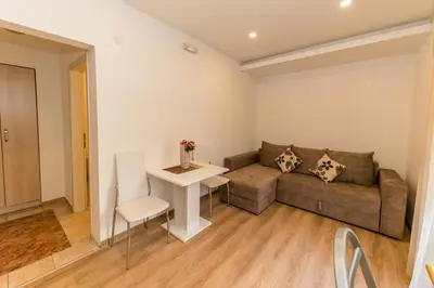 a living room with a couch and a table at Apartmani Stari Grad in Sutomore