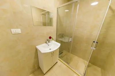 a bathroom with a sink and a shower at Apartmani Stari Grad in Sutomore