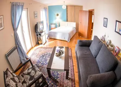 a living room with a couch and a bed at Gala’s Miracle Garden in Budva