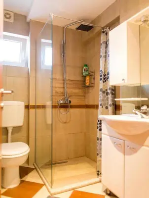 a bathroom with a shower and a toilet and a sink at Gala’s Miracle Garden in Budva