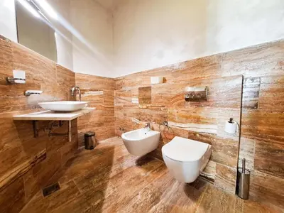 a bathroom with a toilet and a sink at Casa Oliva Villa A with heating pool in Budva