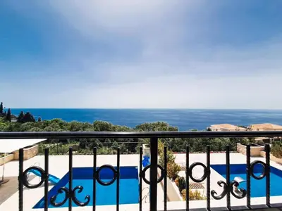 a balcony with a view of a swimming pool at Casa Oliva Villa A with heating pool in Budva