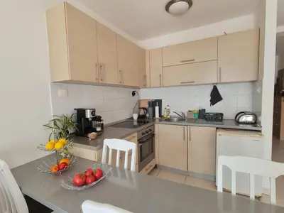 a kitchen with a table with a bowl of fruit on it at The Sun & Sea Apartment in Becici