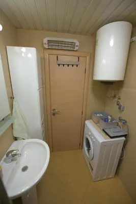a small bathroom with a sink and a washing machine at The Sun & Sea Apartment in Becici