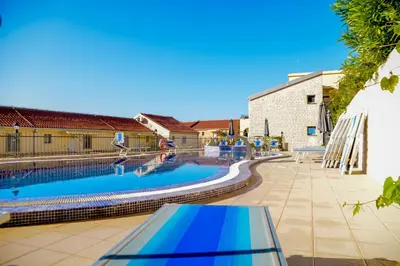 a swimming pool in the middle of a yard at The Sun & Sea Apartment in Becici